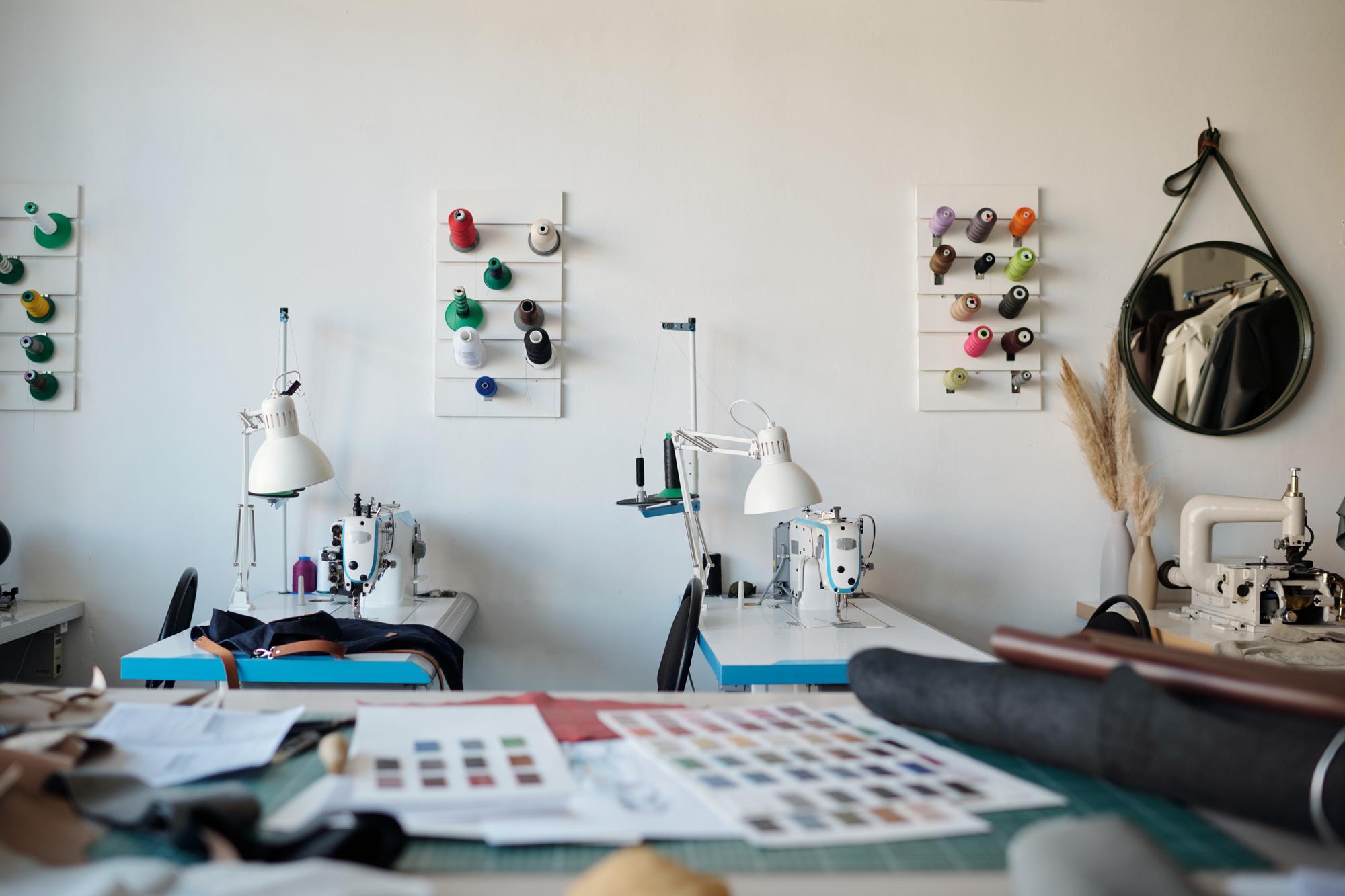 Studio workspace with embroidery machines and screens